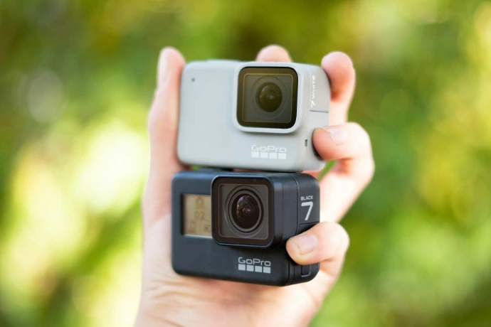 person holding black and gray polaroid camera